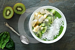 Healthy green smoothie bowl on slate