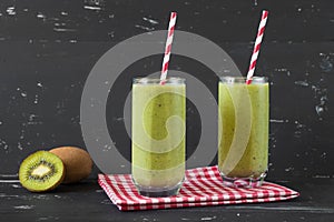 Healthy green smoothie on the dark background