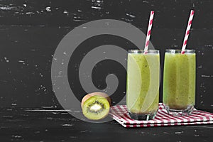 Healthy green smoothie on the dark background