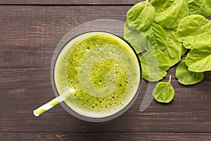 Healthy green smoothie on rustic wood background