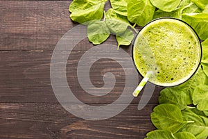 Healthy green smoothie on rustic wood background