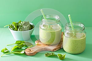 Healthy green smoothie with spinach mango banana in glass jars