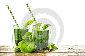 Healthy green spinach leaves smoothie in transparent glass