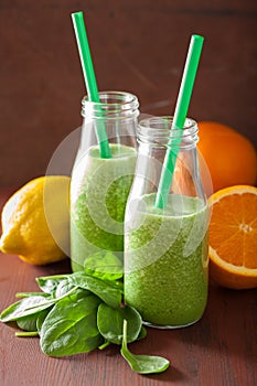 Healthy green spinach smoothie with lemon orange