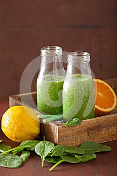 Healthy green spinach smoothie with lemon orange