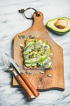Healthy green veggie breakfast concept with sandwich on wooden board