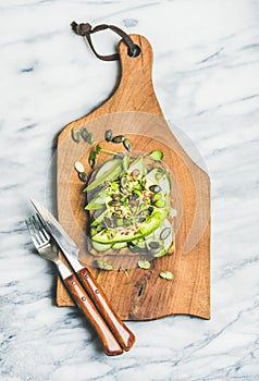 Healthy green veggie sandwich with avocado, cucumber, seeds, sporouts