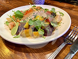 Healthy grilled sea trout salmon fillet fish with roast heritage beetroot and pepper leaf salad. Nutritious fish meal for diet and