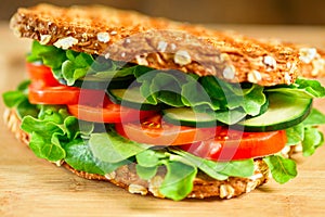 Healthy grilled vegan sandwich made of sprouted organic bread, tomato, cucumber, spinach and arugula