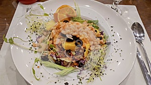 Healthy gurmet shrimp salad with orange in the white plate