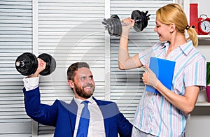 Healthy habits in office. Man and woman raise heavy dumbbells. Strong powerful business strategy. Good job concept. Boss