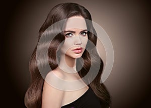 Healthy hair. Beautiful Brunette Girl portrait. Healthy Long wavy hairstyle. Beauty makeup. Model Woman advertising shampoo & ski