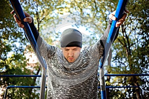 Healthy handsome active man with fit muscular body doing workout exercises. Outdoor. Sports and fitness concept