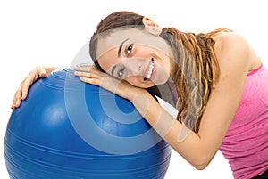 Healthy happy fitness woman sitting next to an exercise ball