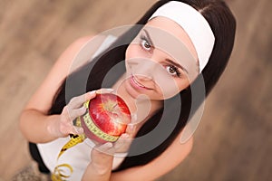 Healthy happy woman with apple and tape measure for diet and weight loss concept