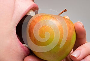 Healthy happy woman eating apple close macro. Biting an apple. Mouth close up. Dental Care.
