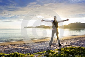 Healthy happy woman enjoying a sunny morning on the beach