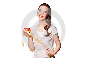 Healthy happy woman with red apple and tape measure