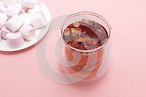 Healthy herbal rose petals, buds tea in double walled glass mug, cup. Pink white