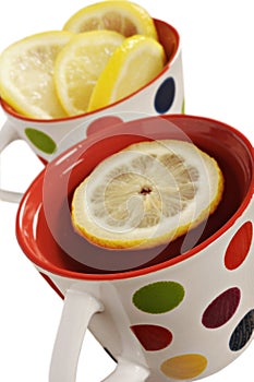 Healthy herbal tea with lemon in polka dot cups