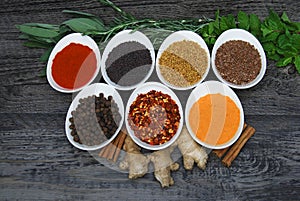 Healthy herbs and spices in dishes on rustic background