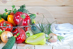 Healthy homegrown food. Fresh organic vegetables in wicker basket on wooden table.