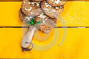 Healthy homemade biscuits from oat flakes laid on orange table