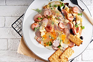 Healthy homemade breakfast. eggs with sausages , spices ,arugula served in a plate