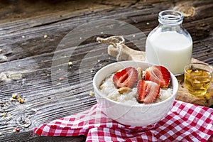 Healthy homemade breakfast. Fresh milk porridge with garden ripe strawberries