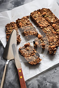 Healthy homemade gluten free sugar free vegan food. Oatmeal chocolate granola bars with almonds and amaranth seeds in baking paper