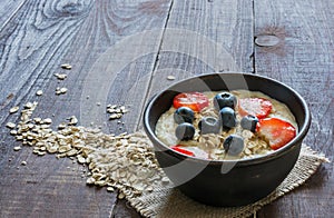 Healthy homemade oatmeal porridge with berries for breakfast
