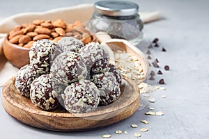 Healthy homemade paleo chocolate energy balls with rolled oats, nuts, dates and chia seeds, horizontal copy space