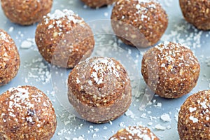 Healthy homemade paleo energy balls with carrot, nuts, dates and coconut flakes, on tray horizontal