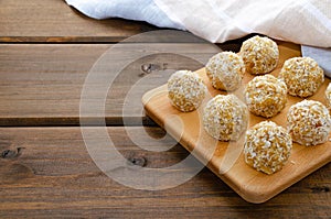 Healthy homemade sweet energy balls of dried fruits and nuts in coconut. The composition of dried apricots, raisins, figs, dates,