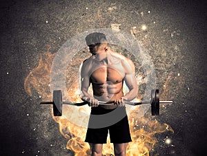 Healthy hot male showing muscles with fire