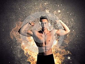 Healthy hot male showing muscles with fire