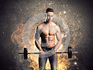 Healthy hot male showing muscles with fire