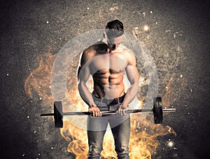 Healthy hot male showing muscles with fire