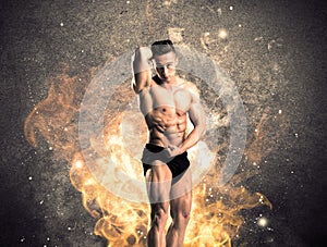 Healthy hot male showing muscles with fire