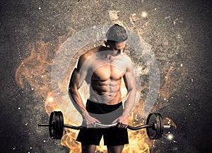 Healthy hot male showing muscles with fire