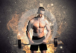 Healthy hot male showing muscles with fire