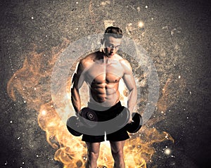 Healthy hot male showing muscles with fire