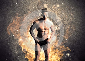 Healthy hot male showing muscles with fire