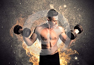 Healthy hot male showing muscles with fire