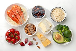 Healthy Ingredients arrangement Featuring Vegetables, Salmon, Nuts, and Fruits on White Surface photo