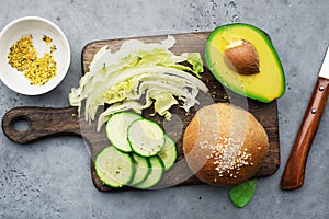 Healthy ingredients clean food. Avocado, whole grain bread, greens, lettuce, vegetables for a comfortable diet. Top view