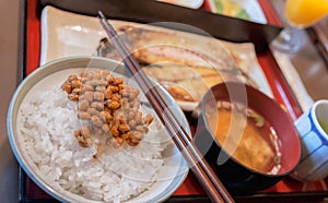 Healthy Japanese breakfast with Miso soup, grilled fish, rice and fermented soy beans called Natto