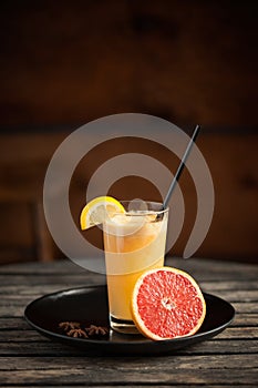 Healthy juice made of red orange, on wooden table