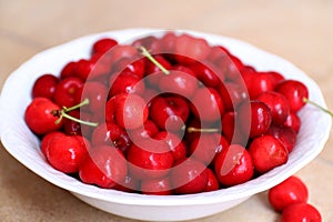 Healthy, juicy, fresh, organic cherries in fruit bowl close up. Cherries in background.