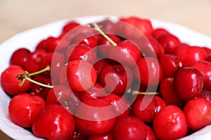 Healthy, juicy, fresh, organic cherries in fruit bowl close up. Cherries in background.